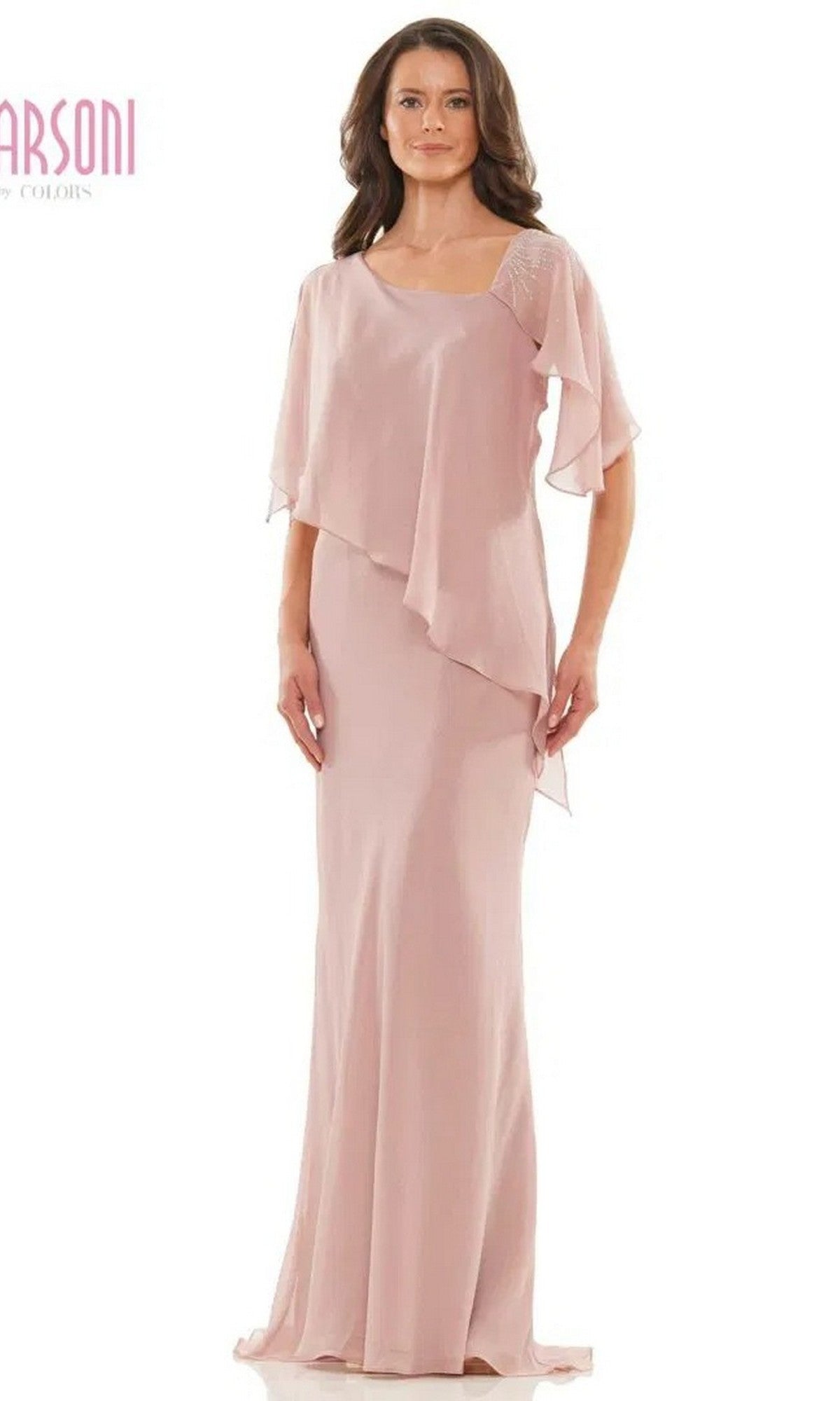 A woman in a mauve Marsoni M313 long formal dress with layered asymmetrical chiffon, short flutter sleeves, and a graceful floor-length sheath skirt stands against a plain background.